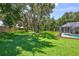 Expansive backyard with mature trees and a screened pool area at 805 Woodcarver Ln, Brandon, FL 33510