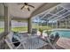 Relaxing covered patio with seating area overlooking the pool and backyard at 805 Woodcarver Ln, Brandon, FL 33510