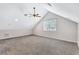 Bonus room with vaulted ceiling, window, and carpet at 805 Woodcarver Ln, Brandon, FL 33510