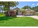 Attractive single-story home with stone accents and lush landscaping at 805 Woodcarver Ln, Brandon, FL 33510