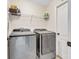 Laundry room with modern washer and dryer and shelving at 805 Woodcarver Ln, Brandon, FL 33510