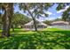 Large backyard with screened pool and lush landscaping at 805 Woodcarver Ln, Brandon, FL 33510