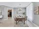 Bright dining area with wooden table and taupe chairs at 805 Woodcarver Ln, Brandon, FL 33510