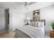 Cozy bedroom with striped bedding and ceiling fan at 102 Apollo Dr, Rotonda West, FL 33947