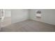 Bright bedroom with carpeted floor and window at 110 Apollo Dr, Rotonda West, FL 33947
