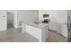 Modern kitchen with white cabinets, stainless steel appliances, and a large island at 110 Apollo Dr, Rotonda West, FL 33947