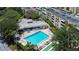 Aerial view of condo community pool, shuffleboard, and building at 2616 Cove Cay Dr # 506, Clearwater, FL 33760