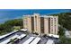 Aerial view of waterfront condo building with parking and water access at 2616 Cove Cay Dr # 506, Clearwater, FL 33760