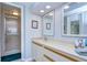 Main bathroom with double vanity, shower, and updated finishes at 2616 Cove Cay Dr # 506, Clearwater, FL 33760