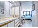 Main bathroom with double vanity, shower, and view into bedroom at 2616 Cove Cay Dr # 506, Clearwater, FL 33760