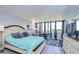 Bright bedroom with a queen-size bed, large windows, and a view at 2616 Cove Cay Dr # 506, Clearwater, FL 33760