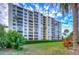 Multi-story building with landscaped grounds and palm trees at 2616 Cove Cay Dr # 506, Clearwater, FL 33760