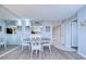 Bright dining room with round table and white chairs at 2616 Cove Cay Dr # 506, Clearwater, FL 33760