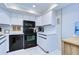 Updated kitchen, featuring white cabinets and black appliances at 2616 Cove Cay Dr # 506, Clearwater, FL 33760