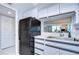 Black appliances and white cabinetry in this galley kitchen at 2616 Cove Cay Dr # 506, Clearwater, FL 33760