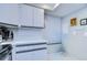 Kitchen with white cabinets, black countertops, and a window at 2616 Cove Cay Dr # 506, Clearwater, FL 33760