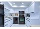 Updated kitchen, featuring white cabinets and black appliances at 2616 Cove Cay Dr # 506, Clearwater, FL 33760