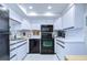 Updated kitchen, featuring white cabinets and black appliances at 2616 Cove Cay Dr # 506, Clearwater, FL 33760