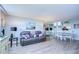 Open living area with gray sofa, hardwood floors, and dining space at 2616 Cove Cay Dr # 506, Clearwater, FL 33760