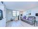 Spacious living room featuring a large window and gray couch at 2616 Cove Cay Dr # 506, Clearwater, FL 33760