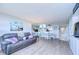 Open living room showcasing a gray sectional and dining area at 2616 Cove Cay Dr # 506, Clearwater, FL 33760