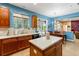Spacious kitchen with island, breakfast nook, and pool view at 21631 Cormorant Cove Dr, Land O Lakes, FL 34637