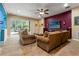 Gathering room with large TV, sectional sofa and access to pool at 21631 Cormorant Cove Dr, Land O Lakes, FL 34637
