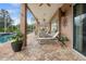 Inviting pool area with brick patio, lounge chairs, and lush landscaping at 21631 Cormorant Cove Dr, Land O Lakes, FL 34637