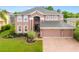 Large two-story house with a spacious yard and brick driveway at 21631 Cormorant Cove Dr, Land O Lakes, FL 34637