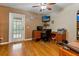 Bright home office features wood floors, built-in desk, and access to a private balcony at 21631 Cormorant Cove Dr, Land O Lakes, FL 34637
