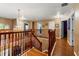Upstairs hall with wood floors and chandelier at 21631 Cormorant Cove Dr, Land O Lakes, FL 34637