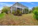Spacious backyard with a screened enclosure and lush landscaping at 21631 Cormorant Cove Dr, Land O Lakes, FL 34637