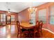 Bright dining room featuring hardwood floors, a large table, and a chandelier at 21631 Cormorant Cove Dr, Land O Lakes, FL 34637