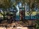 playground with play structures and shaded areas at 21631 Cormorant Cove Dr, Land O Lakes, FL 34637