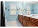 Light and airy bathroom with double vanity, marble countertop, and decorative accents at 21631 Cormorant Cove Dr, Land O Lakes, FL 34637