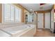 Main bathroom with soaking tub and walk-in shower at 21631 Cormorant Cove Dr, Land O Lakes, FL 34637