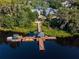 Community dock with gazebo and boat slips on a serene lake at 21631 Cormorant Cove Dr, Land O Lakes, FL 34637
