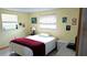 Bright bedroom with a double bed and a red blanket at 13916 Barnard Ave, Hudson, FL 34667