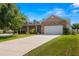 Two-story house with stone accents and a large driveway at 32124 Corbin Ridge St, San Antonio, FL 33576