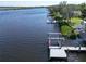 Aerial view of waterfront property with private dock and lush landscaping at 2628 River Bend Dr, Ruskin, FL 33570