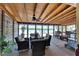 Waterfront screened porch with wicker furniture and ceiling fan at 2628 River Bend Dr, Ruskin, FL 33570