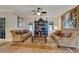 Spacious living room with hardwood floors, comfortable seating, and a large TV at 2628 River Bend Dr, Ruskin, FL 33570