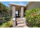 Inviting front porch entry with stone columns and landscaping at 2628 River Bend Dr, Ruskin, FL 33570