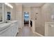 Large bathroom with double vanity, walk-in shower, and view to bedroom at 2628 River Bend Dr, Ruskin, FL 33570
