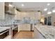 Bright kitchen boasts granite counters, stainless steel appliances, and stylish backsplash at 2628 River Bend Dr, Ruskin, FL 33570