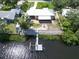 Aerial view of house with backyard, fire pit, and private dock at 2628 River Bend Dr, Ruskin, FL 33570