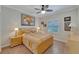 Bedroom with ceiling fan, large window and wood floors at 2628 River Bend Dr, Ruskin, FL 33570