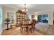 Bright dining room with hardwood floors, large windows, and access to the living room at 2628 River Bend Dr, Ruskin, FL 33570