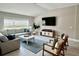 Comfortable living room featuring a sectional sofa and large TV at 4801 Cypress Club Pl, Tampa, FL 33624