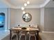 Elegant dining room with a large wooden table and mirror at 4801 Cypress Club Pl, Tampa, FL 33624